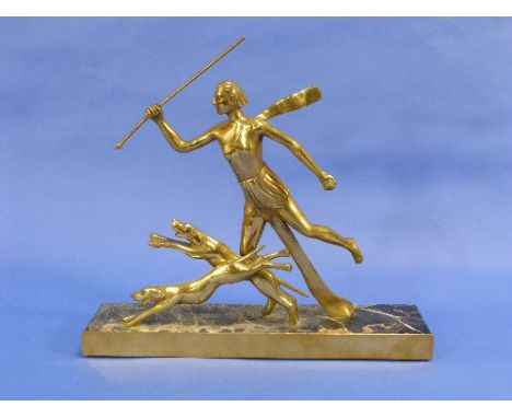 A French Art Deco gilt bronze group of Diana Huntress with Dogs, on rectangular marbled base, 15½in (39.5cm) long.
