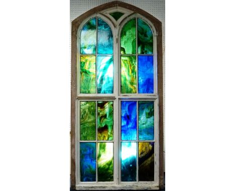 Three antique Gothic-style large stained glass Windows, each window formed of seventeen coloured 'reamy' glass panes set with