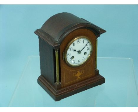 An Edwardian mahogany Mantel Clock, of domed form with inlaid decoration and gilt-metal columns, circular dial and Arabic num