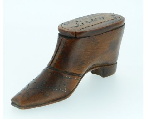 A Georgian carved wood Shoe Snuff Box, with brass stud detailing, the sliding cover inscribed "Love", 4in (10cm) long.