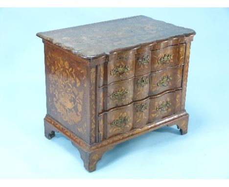 An 18thC Dutch walnut marquetry Commode, inlaid throughout with scrolling foliage and exotic birds, the serpentine shaped top