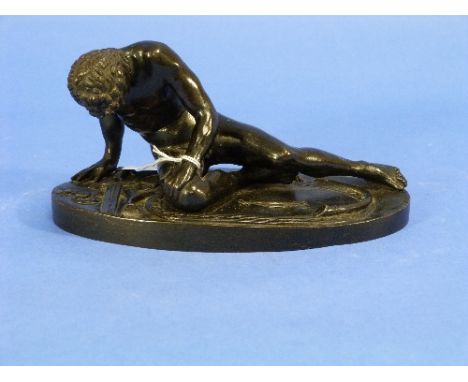 A patinated bronze of the Dying Gaul, on oval base, 7?in (20cm) long.