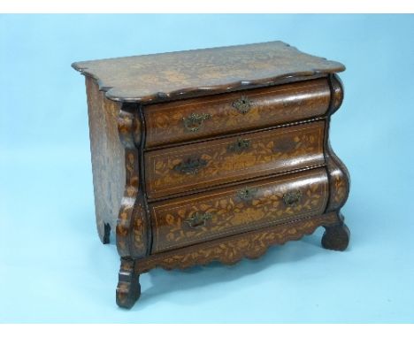 An 18thC Dutch oak marquetry Bombé Commode, inlaid throughout with scrolling foliage and exotic birds, the serpentine shaped 