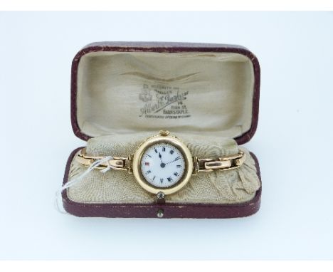 A continental 18ct gold lady's Wristwatch, with Swiss movement marked "S.S.& Co.", the circular white enamel dial with black 
