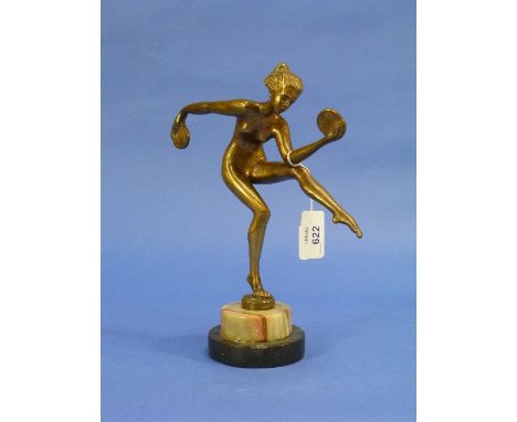An Art Deco gilt bronze figure of a female nude Dancer, holding discs, on small circular base and marbled plinth, 9½in (24cm)