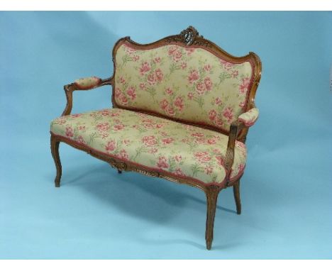 An early 20thC French walnut and upholstered Sofa, with carved show frame, serpentine front and cabriole legs, 48in (122cm) w