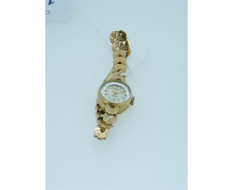 A 9ct gold Rotary lady's Wristwatch, the ½in (1.25cm) diameter silvererd dial with gilt baton numerals and 9ct gold integral 