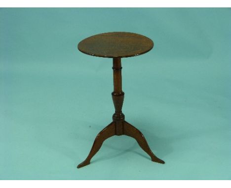 A Georgian oak Wine Table, on turned baluster shaped support on tripod base.