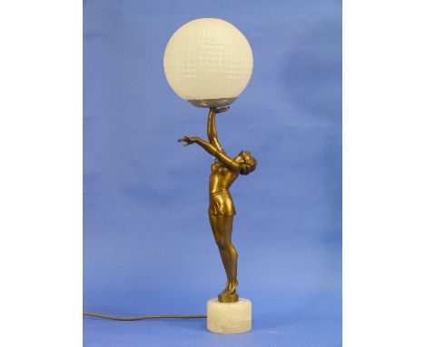 An Art Deco spelter figural lamp base, she partly-clothed standing and supporting a globe, on circular base and polished ston