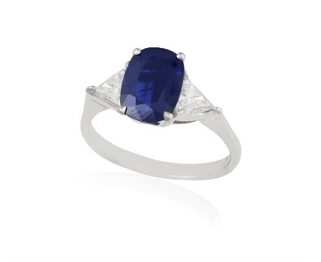 A SAPPHIRE AND DIAMOND DRESS RINGThe oval-shaped sapphire weighing approximately 1.80ct within a four-claw setting and betwee