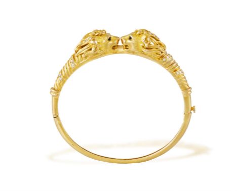 A DIAMOND AND ENAMEL BANGLEThe hinged bangle, designed as two opposite lion heads accented with single-cut diamonds and black
