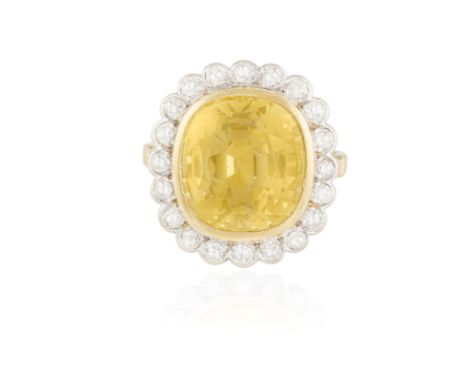A COLOURED SAPPHIRE AND DIAMOND CLUSTER RINGThe cushion-shaped yellow sapphire weighing approximately 12.00cts within millegr