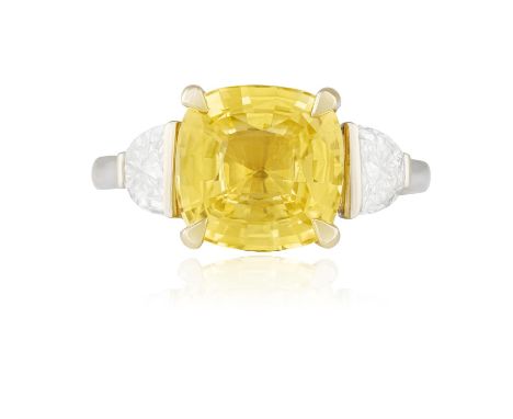 A COLOURED SAPPHIRE AND DIAMOND DRESS RINGThe cushion-shaped yellow sapphire weighing 4.07cts within a four-claw setting and 