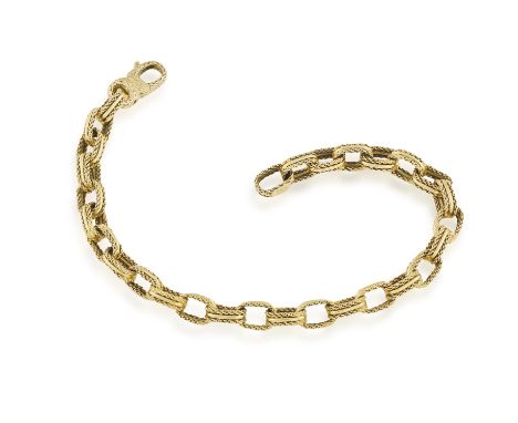 A GOLD BRACELET, BY FRED PARIS, CIRCA 1965Composed of ropetwist fancy gold links with textured gold clasp, in 18K gold, signe