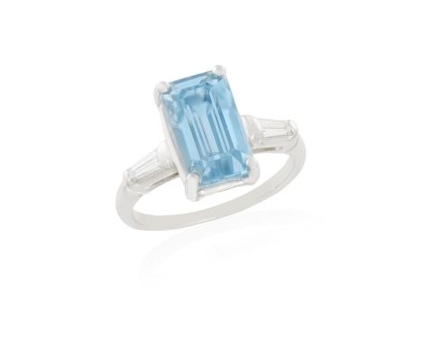 A ZIRCON AND DIAMOND RINGThe rectangular-cut blue zircon weighing approximately 5.80cts within a four-claw setting and betwee