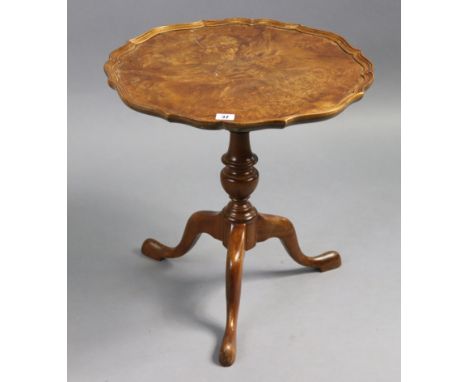 A reproduction walnut tripod table with moulded pie-crust edge to the circular top, &amp; on vase-turned centre column &amp; 