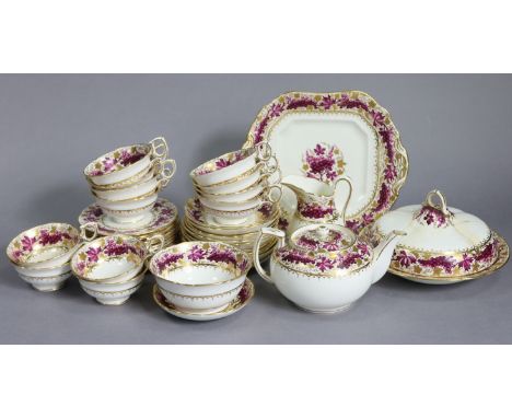 An early 20th century English porcelain tea service in the regency style, the wide borders decorated with grapevines in puce 