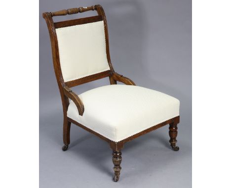 A late Victorian beech-frame square-back armchair with padded back &amp; sprung seat upholstered cream material, &amp; on sho