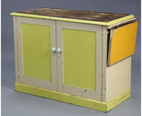 A mid-20th century cream &amp; white painted wooden kitchen side cabinet fitted centre shelf enclosed by a pair of panel door