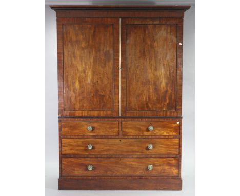 A late 18th/early 19th century mahogany wardrobe with moulded cornice, a hanging compartment to the top section enclosed by p