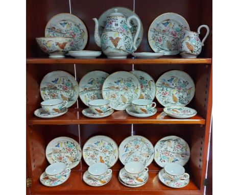 A Japanese porcelain thirty-four piece part tea service of white ground, &amp; with multi-coloured floral &amp; bird decorati