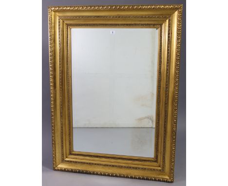 A 19th century-style large gilt frame rectangular wall mirror with gadrooned edge, &amp; inset bevelled plate, 46½” x 34½”.