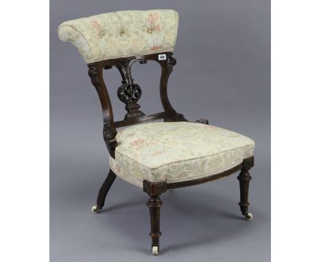 A Victorian carved walnut frame splat-back nursing chair with buttoned-back &amp; sprung seat, on short turned tapering legs 