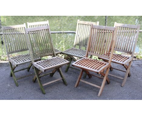 A set of six teak fold-away garden chairs each with slatted seat &amp; back, &amp; on square legs.