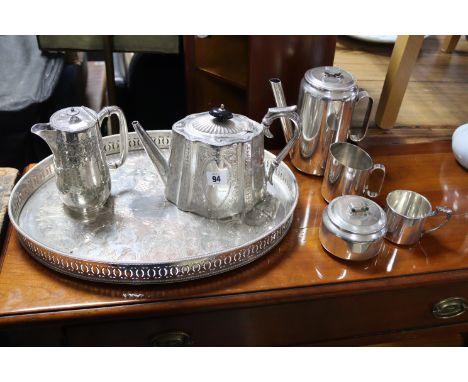 A late 19th century engraved silver plated oval teapot; a similar hot-water jug; a matching oval tea tray; &amp; various othe