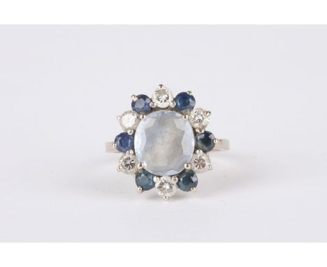 An Art Deco Sapphire and diamond cluster ring
set with central pale blue sapphire surrounded by alternating sapphires and dia