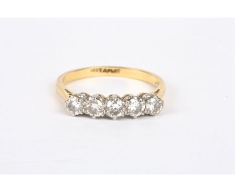 An 18ct gold and diamond five stone ring
set with five circular diamond weighing approximately 0.16-0.18cts each, set in plat