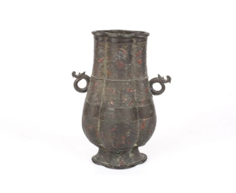 A Chinese bronze and enamel archaic hu vase
18th or 19th century, decorated with bands of scrolls and symbols, retaining trac