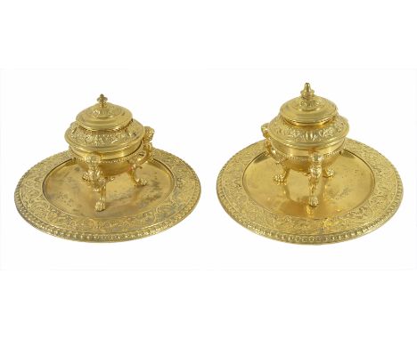 A pair of ornate gilt brass inkwells
circa 1880
each with foliate cast well with three mounted cherubs on a circular base wit