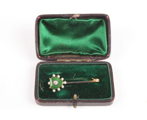 A Victorian diamond and enamel bar brooch
set with green enamel heart surrounded by seed pearls and mounted in the centre wit