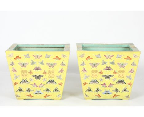 A large pair of Chinese yellow ground rectangular trough planters
the tapered bodies decorated all over with butterflies and 