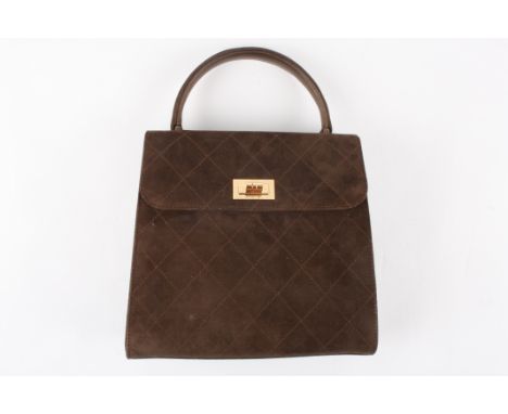A small brown suede Chanel handbag
of slightly tapered form with stitching in diamond patterns, gold coloured clasp Dimension