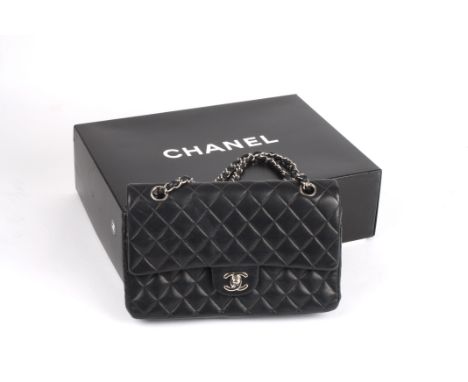 A leather quilted black Chanel handbag. 
the leather double flap bag from Chanel featuring a rectangular body, a front flap c