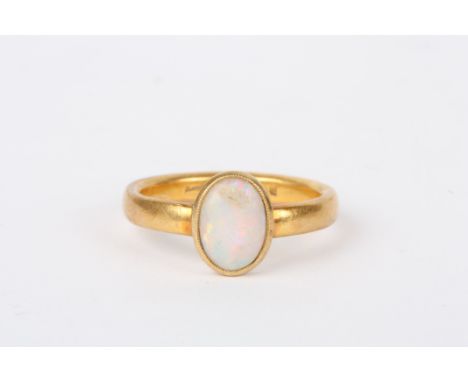 A 22ct gold and opal ring
with Birmingham hallmark, with rubover setting and plain shank.Dimensions: Size P.Condition reportG