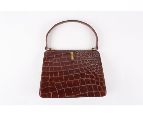 A 1930's crocodile handbag
of slightly tapered form, the brown coloured bag with gold coloured clasp. Inside zip compartment 