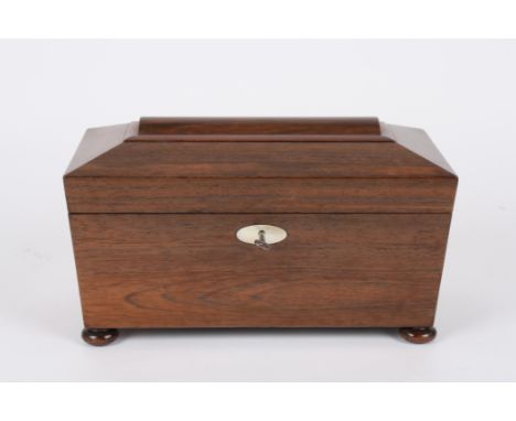 A 19th century sarcophagus shaped rosewood tea caddy
the interior with glass mixing bowl and twin removable lids, supported o