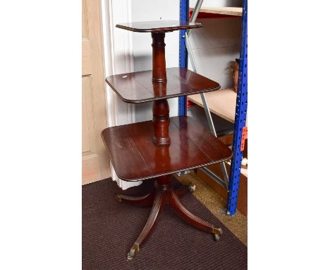 An Early 19th century Mahogany Three Tier Dumb Waiter, rasied on ring turned column supports to four outswept legs with brass