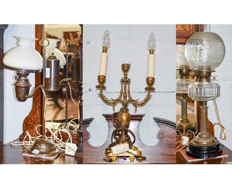 A Victorian Oil Lamp, converted for electricity; together with a gilt metal twin light table lamp and a 20th century example 