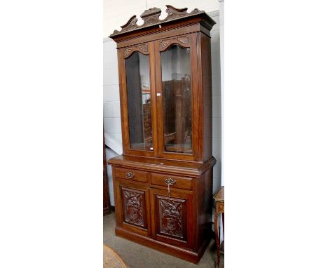 A Late Victorian Walnut Glazed Bookcase, broken pediment to cornice, twin  glazed doors below, with adjustable shelf interior