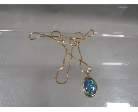 An opal style pendant stamped 375 on a hallmarked 9 carat gold chain approx weight chain only 2.4g