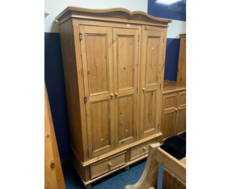 A pine triple wardrobe with two drawers to the base H 213 cm W 138 cm 