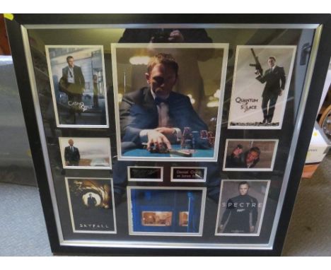A FRAMED COLLECTION OF DANIEL CRAIG PICTURES - ONE AUTOGRAPHED, featuring the films Quantum of Solace, Skyfall, Spectre and C