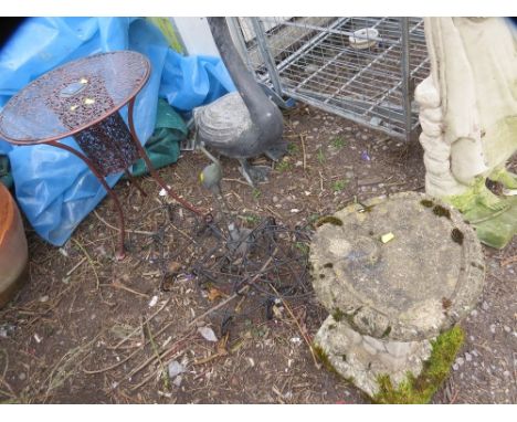 A selection of steel and brass garden items to include wrought iron planter, stands, table, swan, and a brass pelican