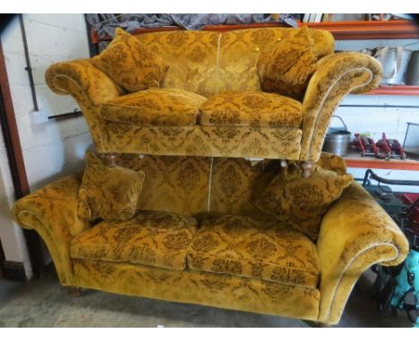 A gold velour two piece suite comprising a 3 setaer plus a 2 seater sofa, with wooden legs and feather filled cushions