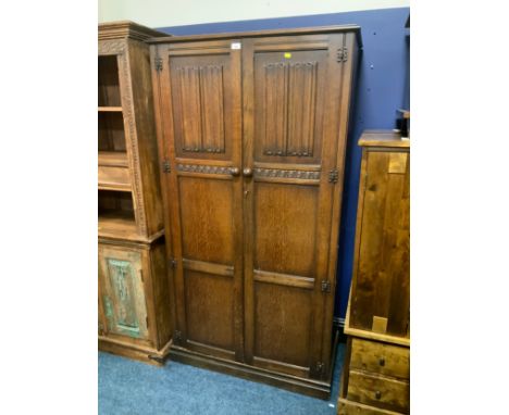 An oak two door linenfold wardrobe 