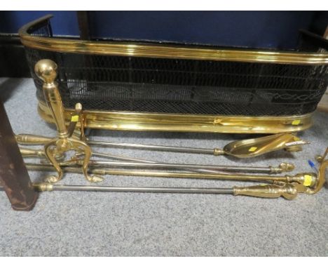 A vintage brass fireguard, fire dogs and poker etc